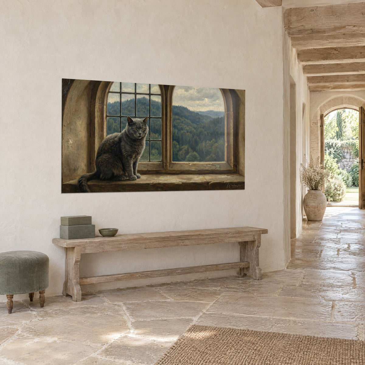 Wall art of a slate-furred cat sitting in a beige arched alcove, green wooded hills, on a stone house wall