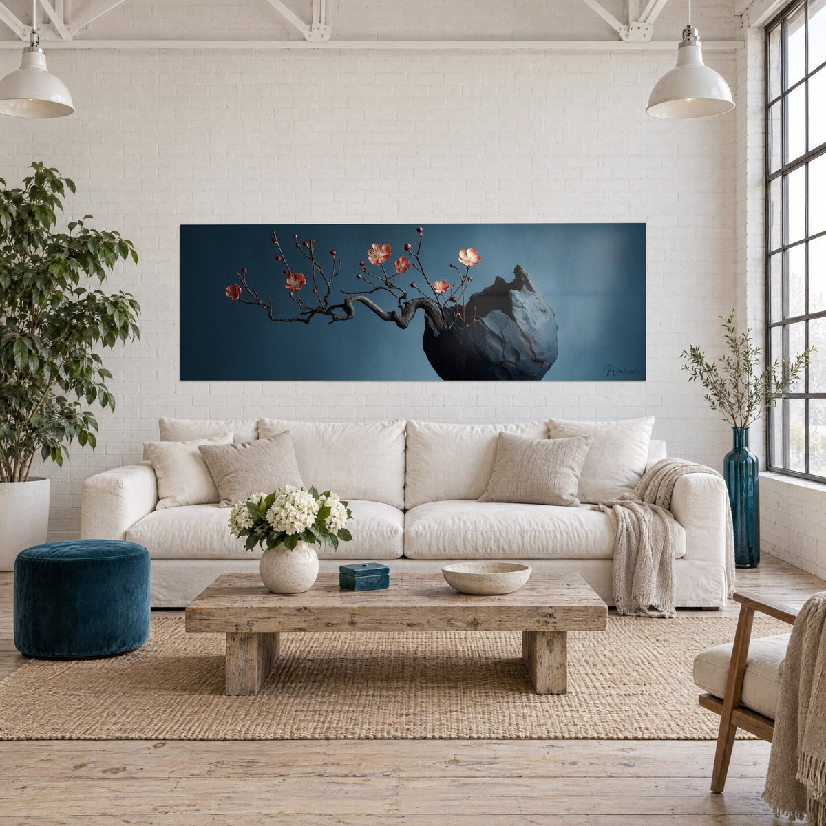 Wall art plum branch with coral blossoms on a midnight blue background, black stone vase, above a sofa in a bright living room