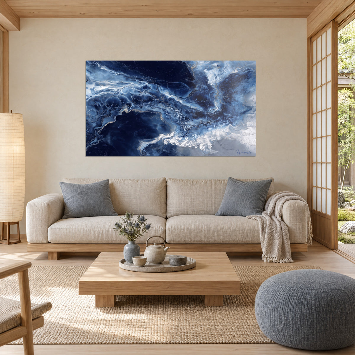 Wall art abstract marble in midnight blue veined with white and gold, pearly foam bottom right, above a sofa in a bright living room