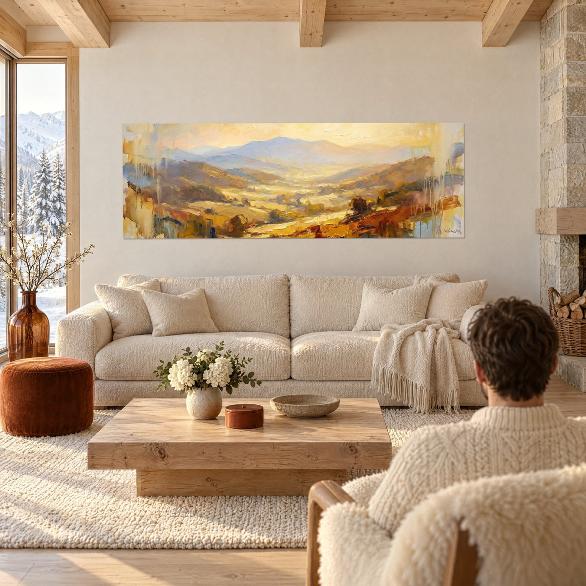Wall art golden valley with ochre hills and lavender-blue mountains, paint drips, above a sofa in a bright living room