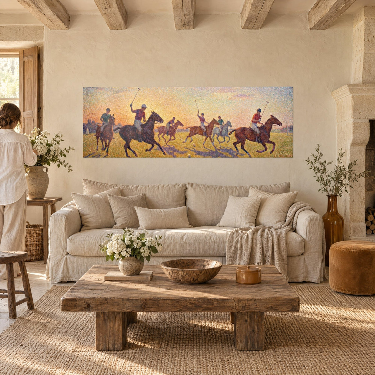 Wall art polo players galloping under an orange and yellow sky, red and green jerseys, above a sofa in a bright living room