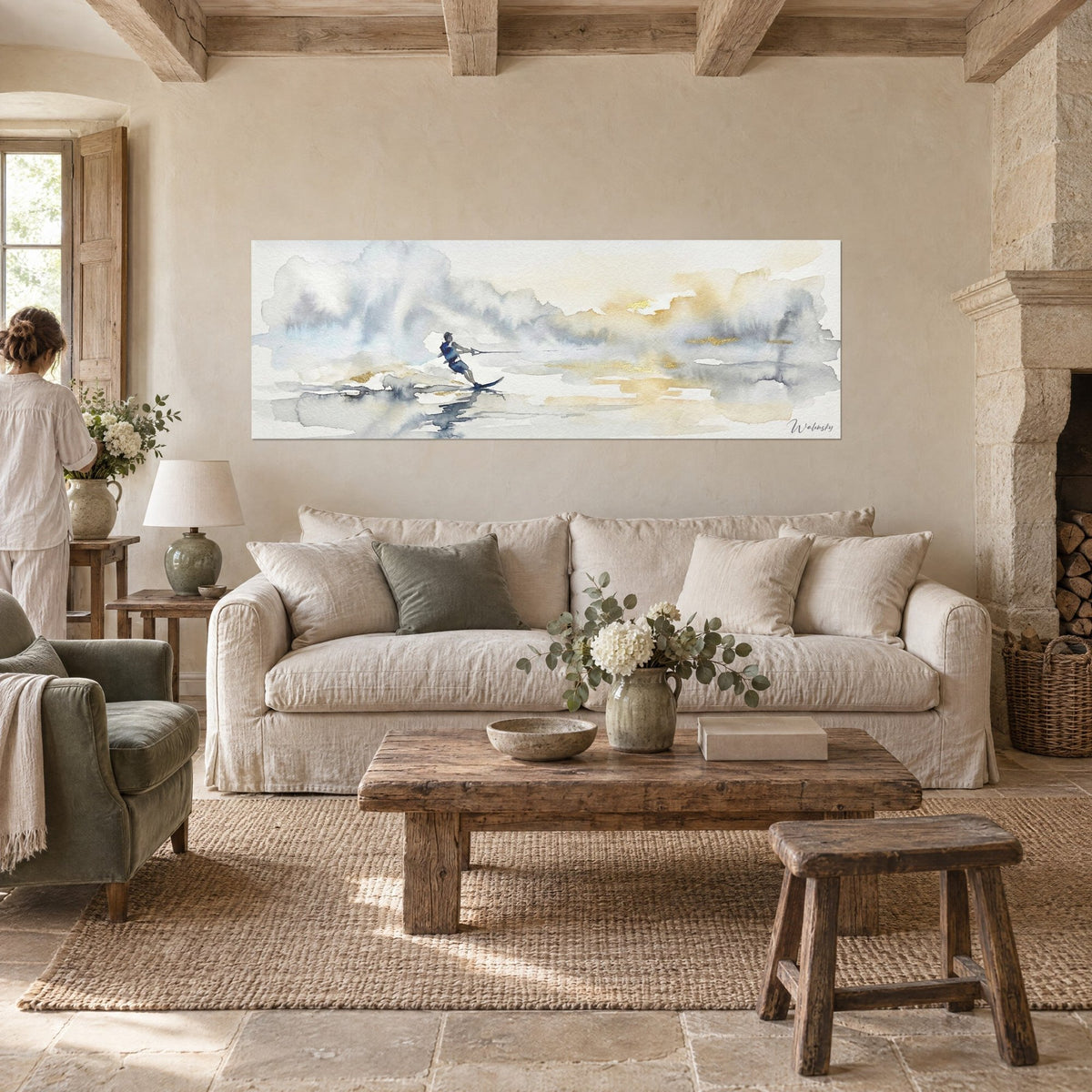Wall art watercolor water skier in midnight blue gliding over grey and gold mist, above a sofa in a bright living room