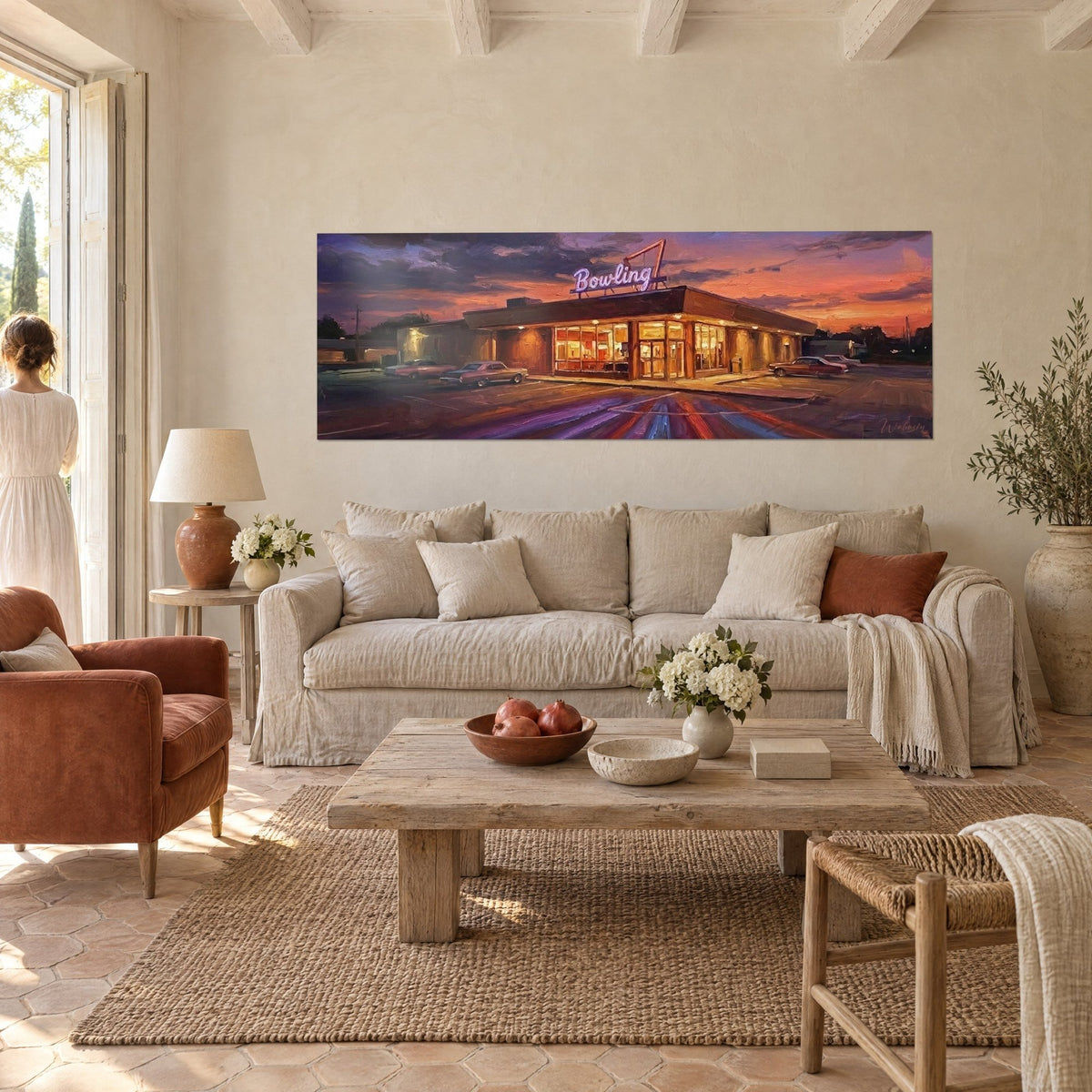 Wall art vintage bowling alley with pink neon under an orange and purple sky, classic cars, above a sofa in a bright living room