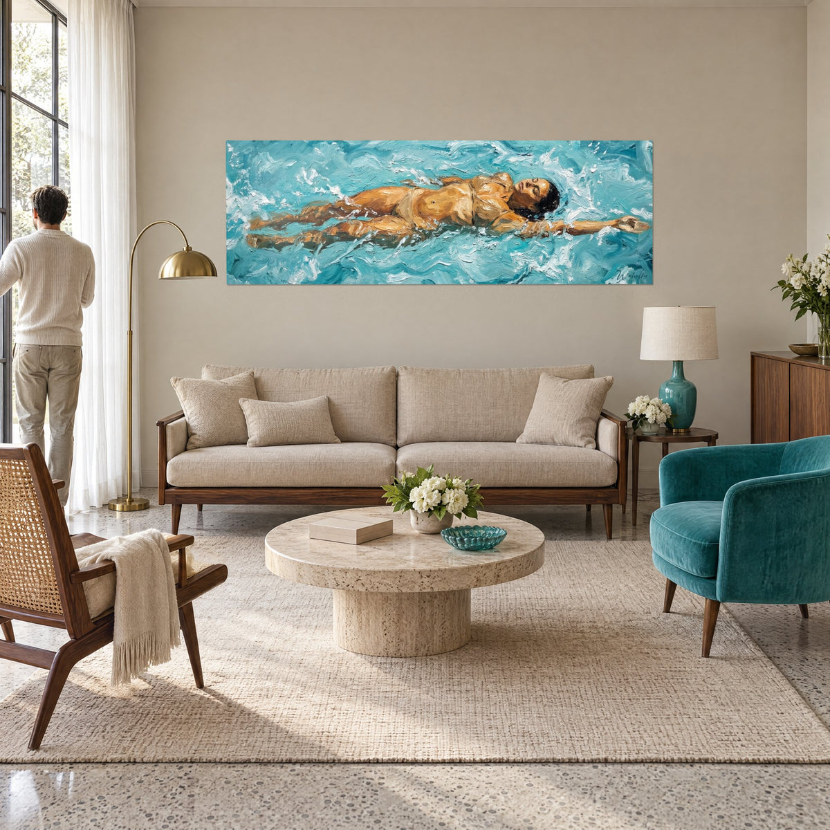 Wall art of a woman swimming on her back in turquoise water, amber skin and white foam, above a sofa in a bright living room