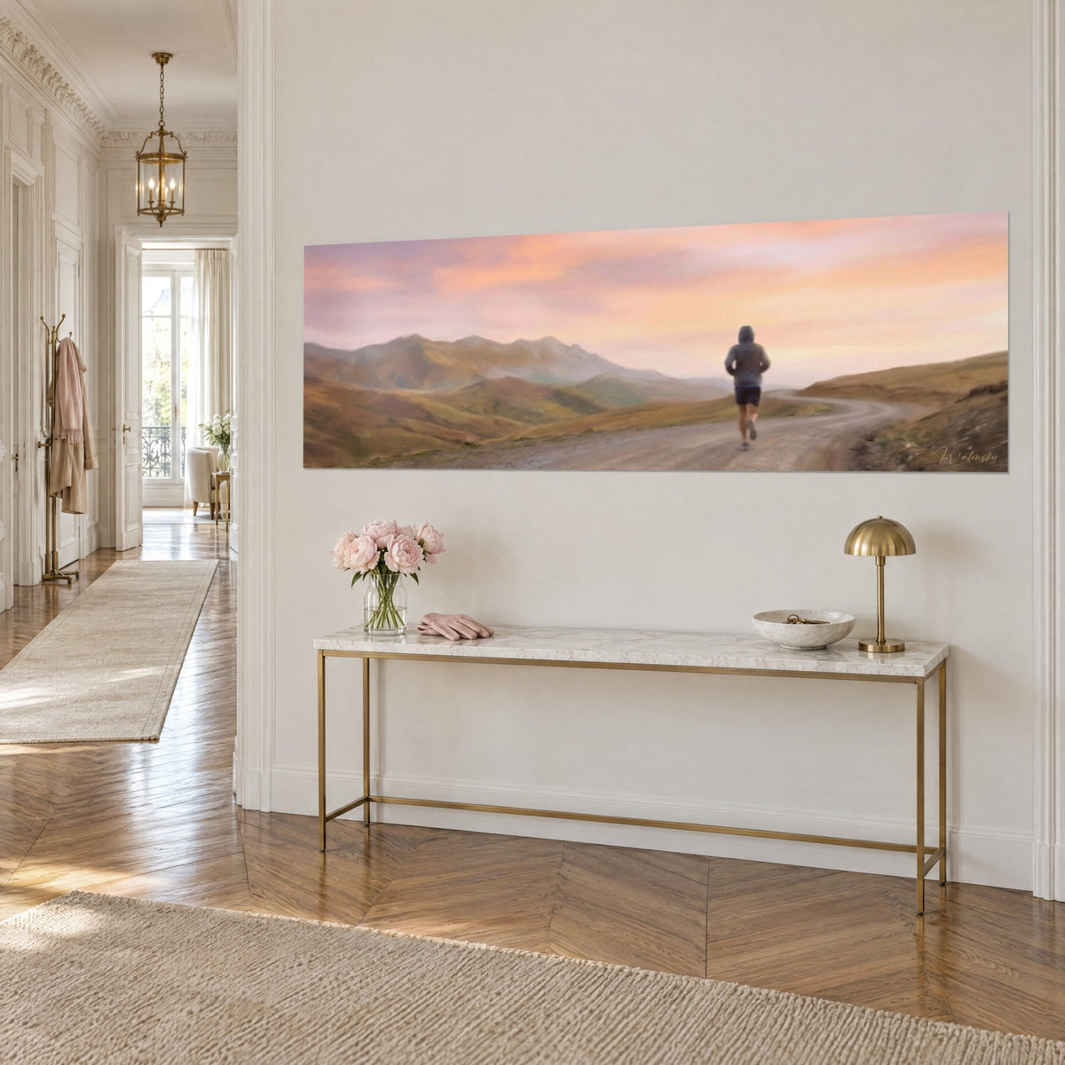 Wall art of a sporty runner seen from behind on a dirt path, ochre and greenish ridges, pastel sky, on a gilded Haussmann console