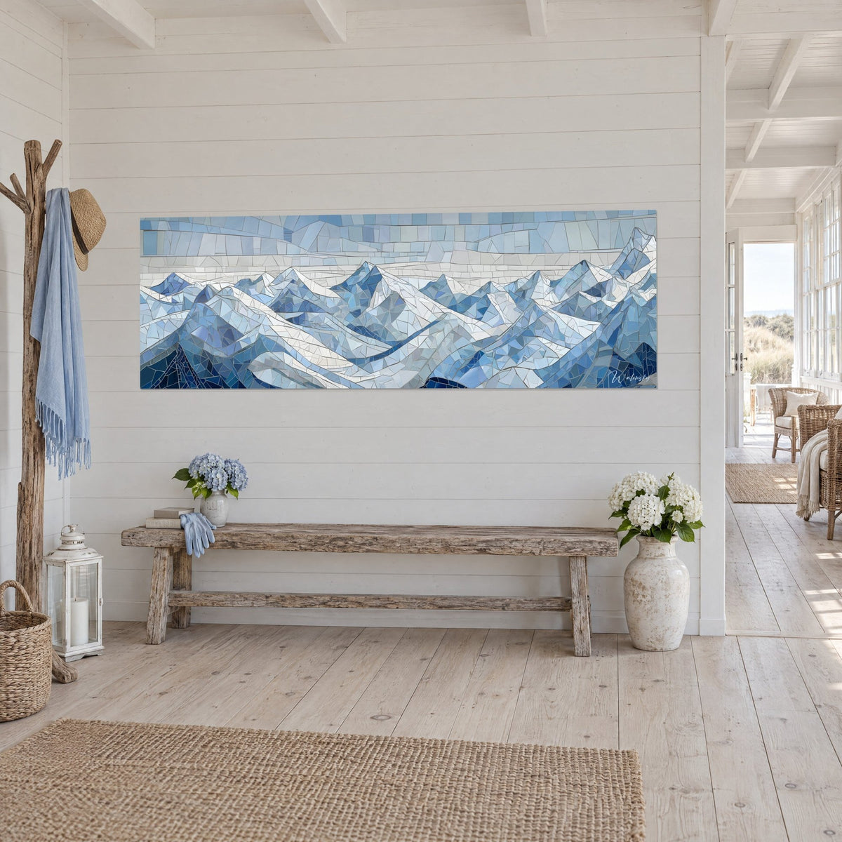 Wall art snowy mountain ridge in navy and pearl grey tesserae, silver grout lines, on a white panelled wall beside a bench