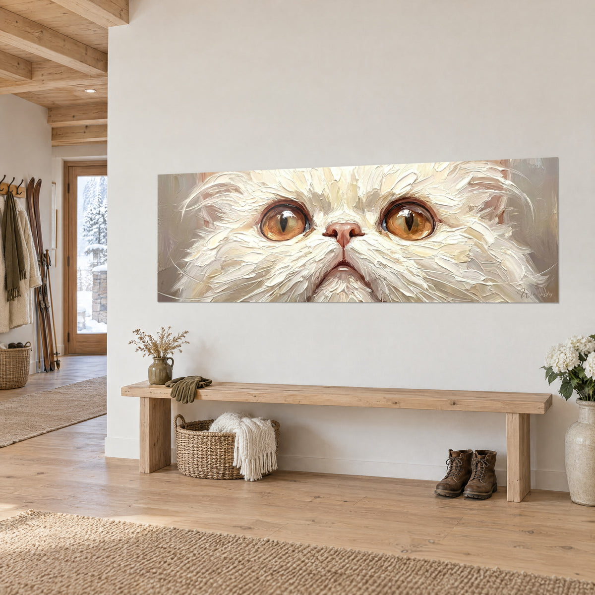 Cuadro rostro de gato blanco de grandes ojos dorados, fondo gris topo, en una pared clara sobre un banco de madera estilo chalet