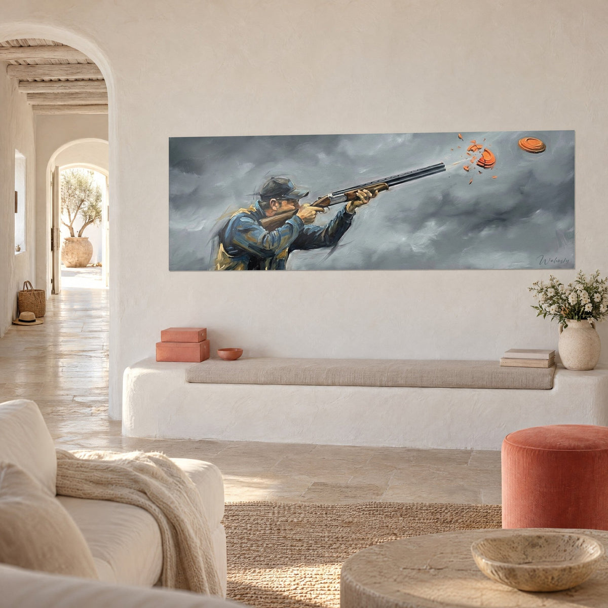 Wall art of an over-under shotgun aimed at a shattered orange clay target, dark cap and grey clouds, white wall of a Mediterranean house