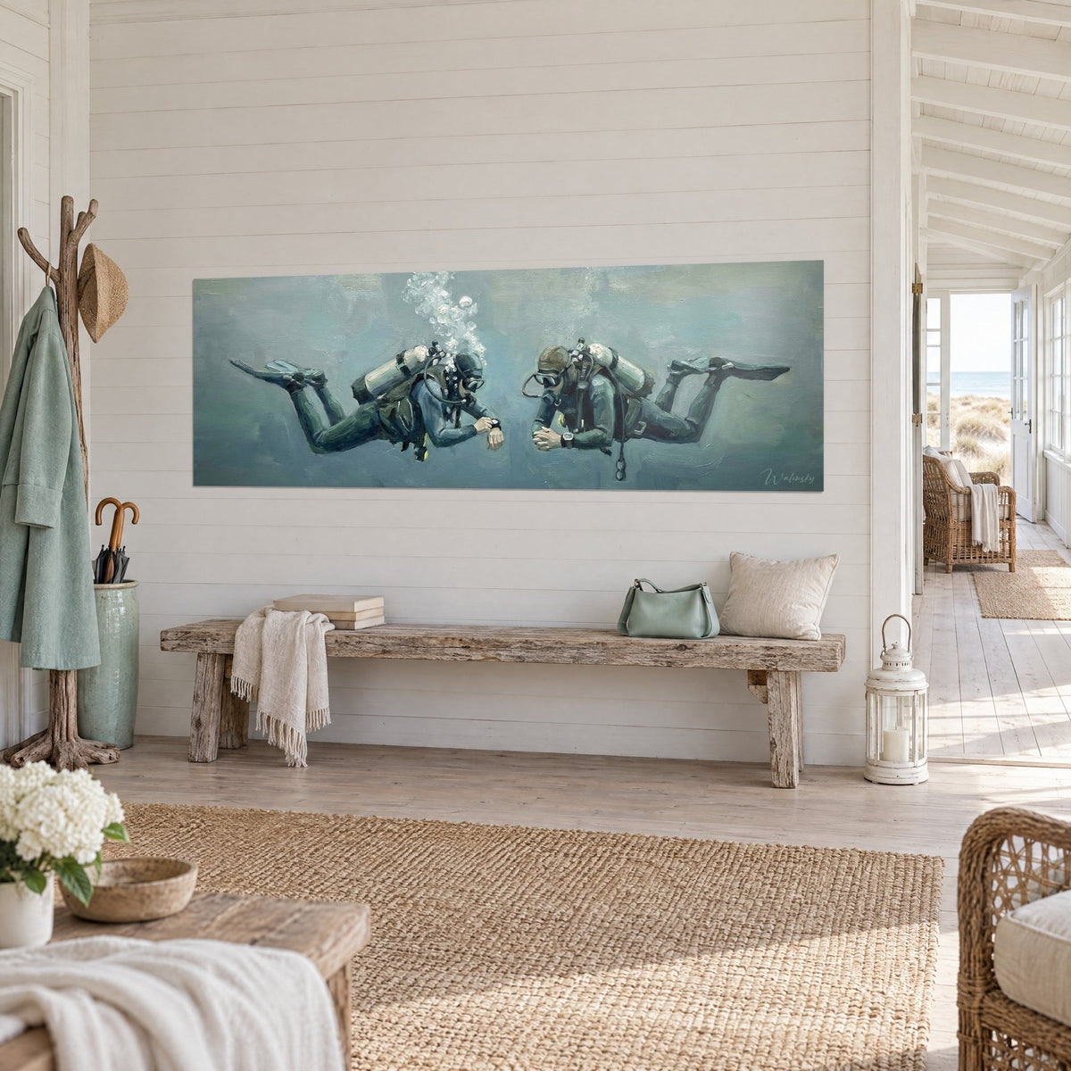 Wall art of a diving duo in olive wetsuits, ivory tanks and rising bubbles against a blue-green background, seaside living room, three-quarter view