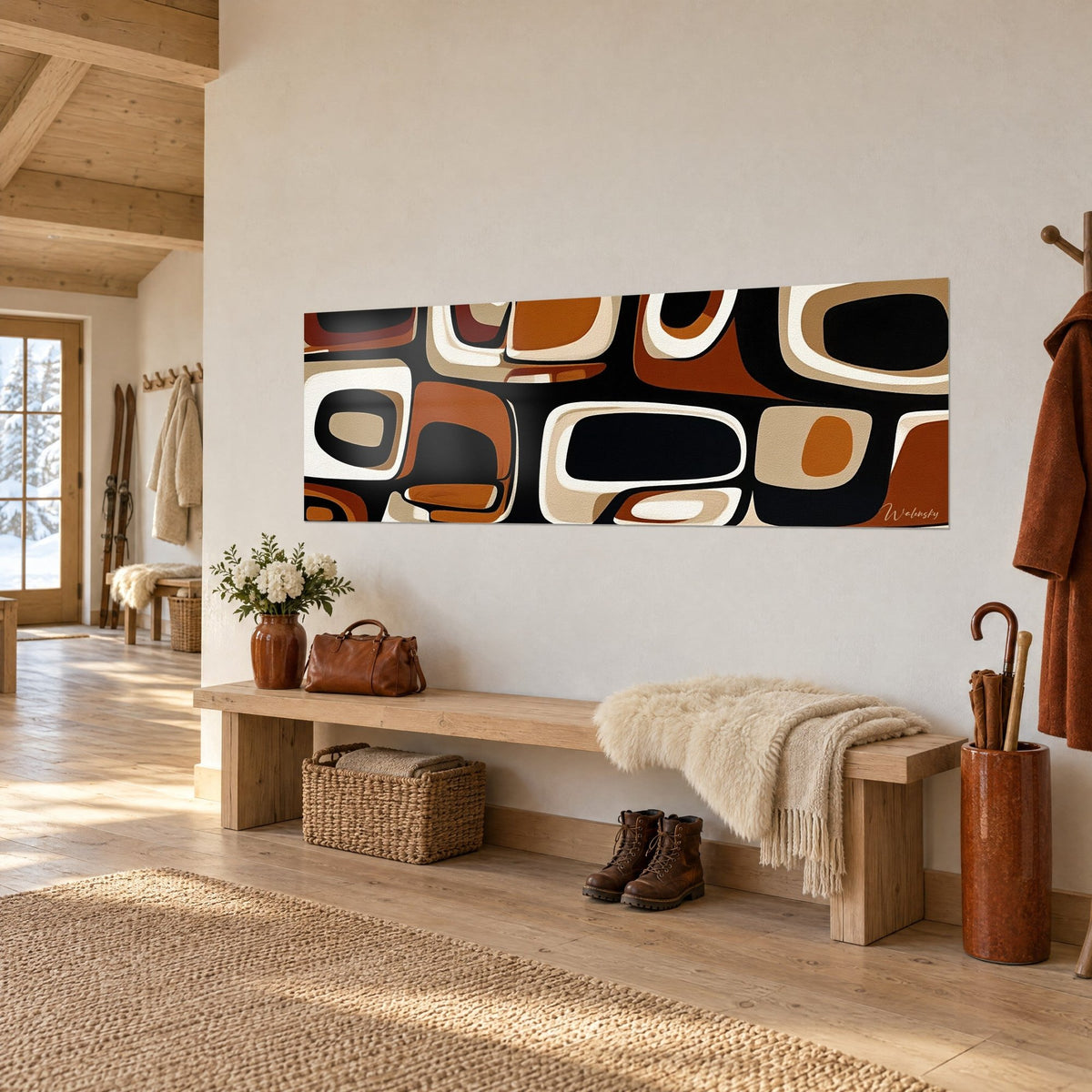 Panoramic wall art of black, caramel and sand pebble blocks, three-quarter view, above a wooden entryway bench