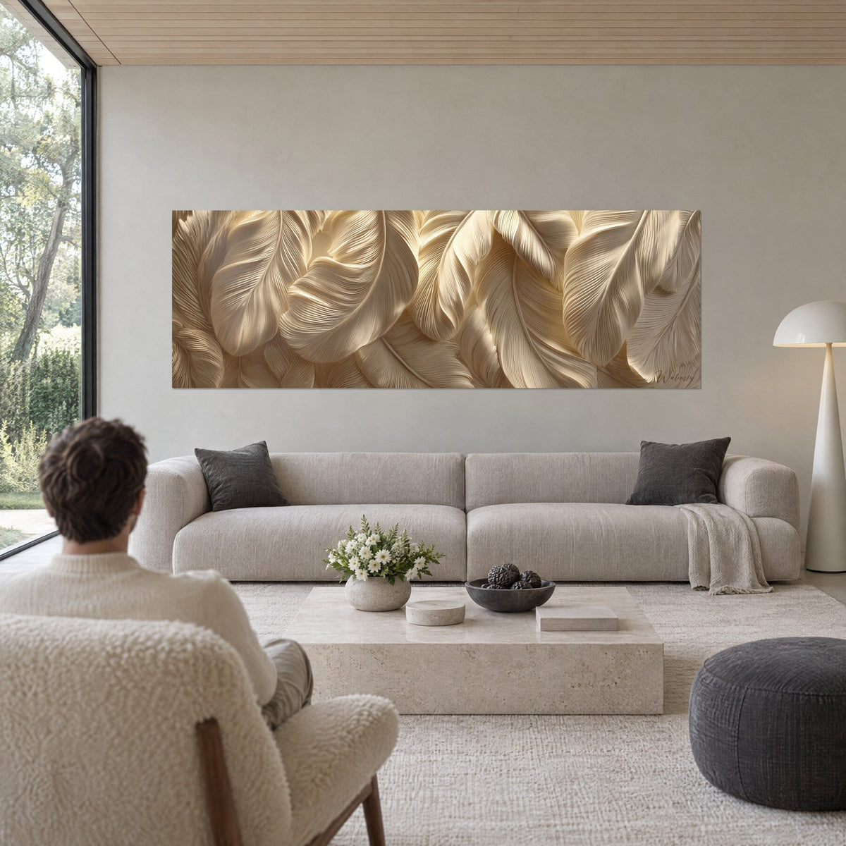 Wall art with sculpted feathers in ivory and gold, finely striated barbs, hung above a sofa in a bright living room