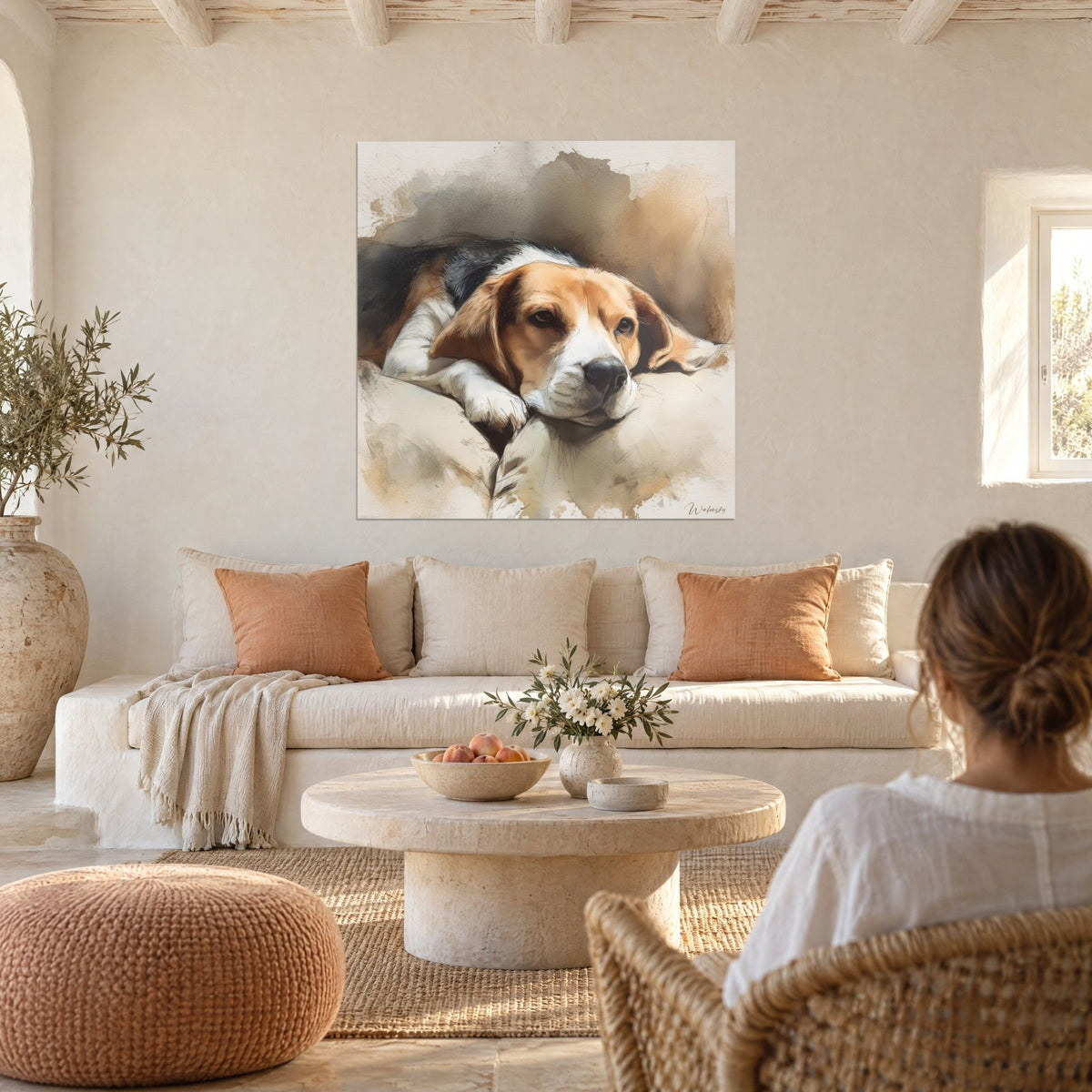 Wall art of a dozing beagle, ochre ears and white coat on a beige cushion, above a sofa in a bright living room