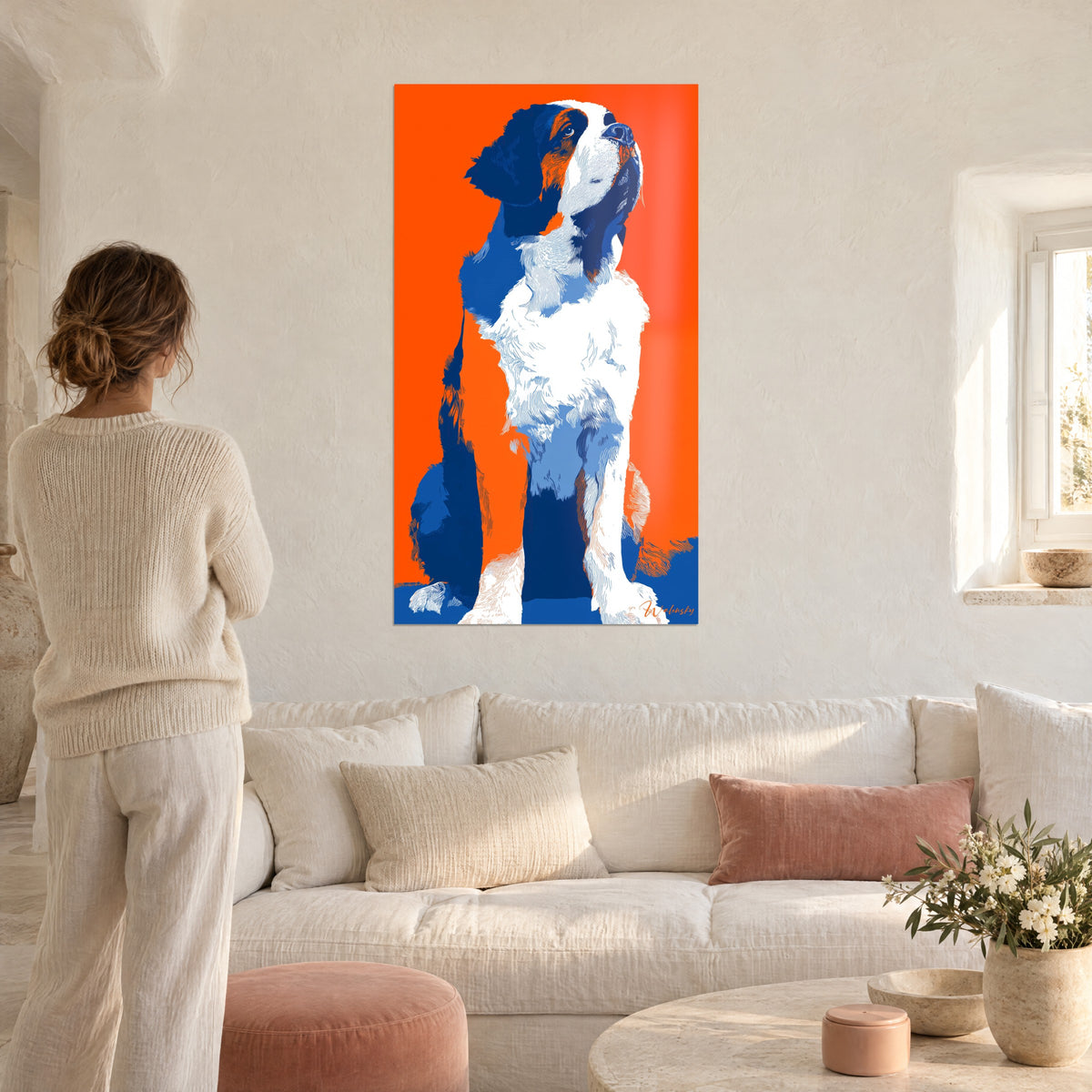 Quadro cucciolo di San Bernardo seduto su sfondo arancione vivo, pelo bianco e blu cobalto, sopra un divano in un soggiorno luminoso