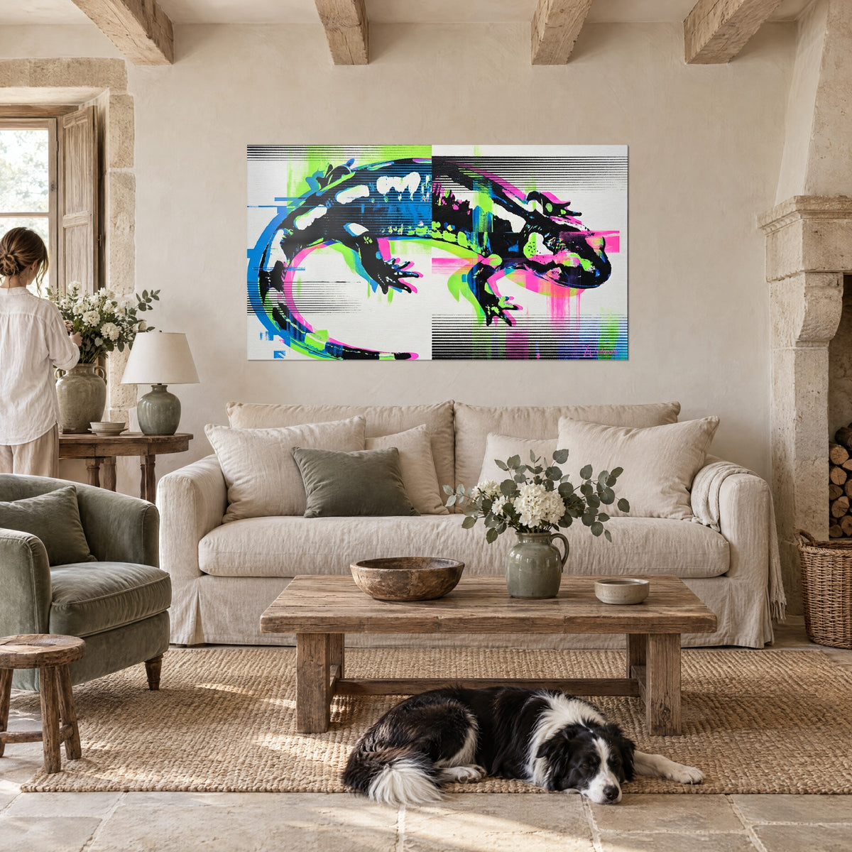Wall art black salamander with white spots, neon green and pink streaks, two people seen from behind above a sofa in a bright living room