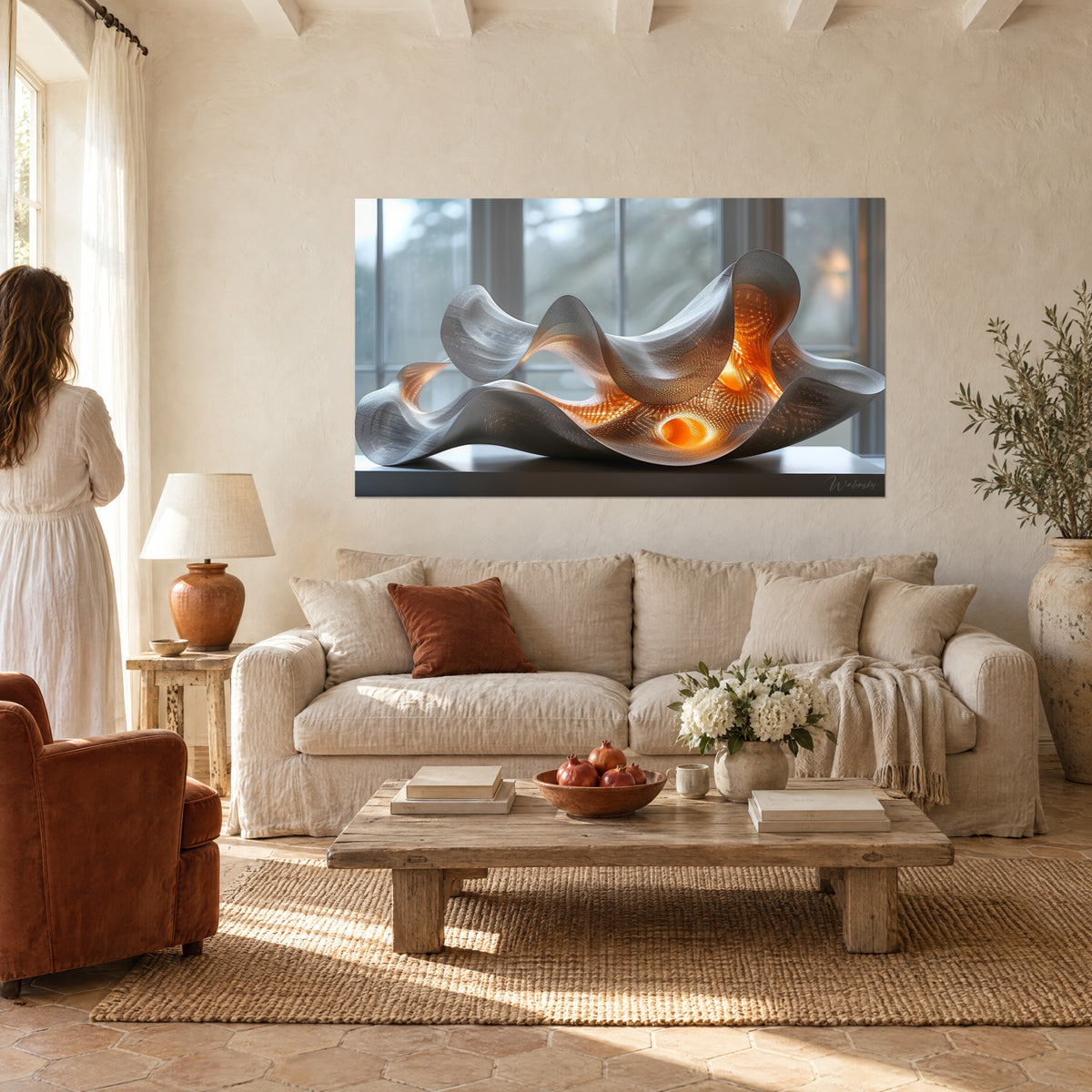 Wall art of a wavy silver sculpture lit in orange, two people seen from behind, above a sofa in a bright living room
