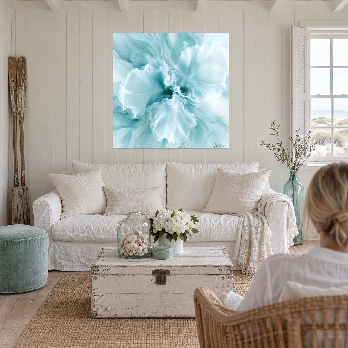 Tableau fleur éthérée aux pétales de soie turquoise et blancs, cœur bleu profond, au-dessus d'un canapé dans un salon lumineux