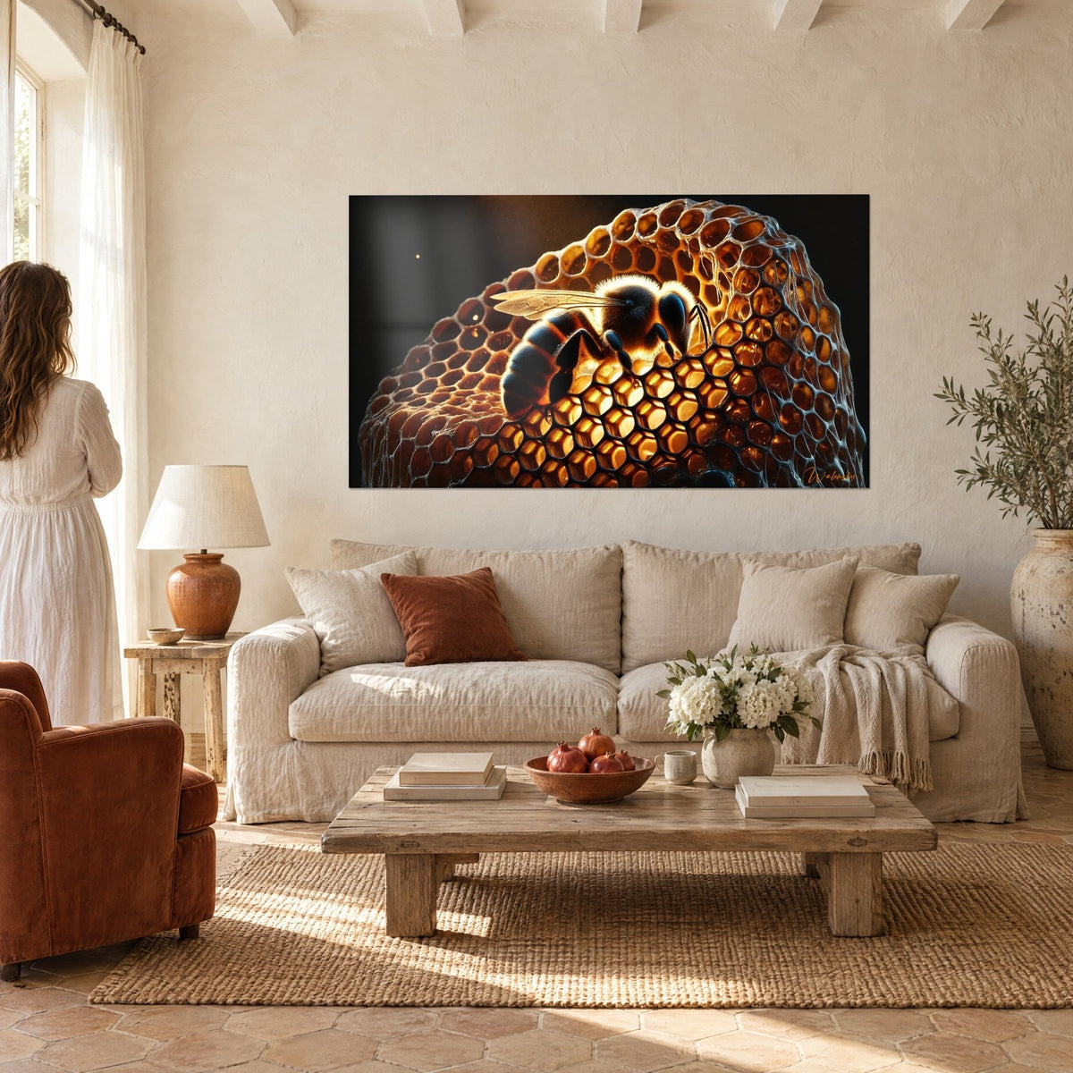 Wall art golden bee with furry body, translucent wings over honeycomb cells of black and amber wax, above a sofa in a bright living room