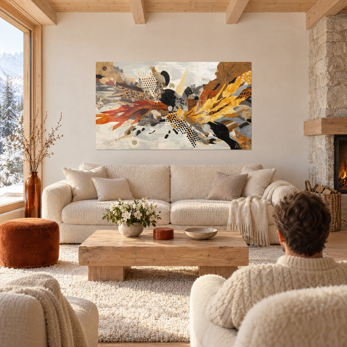 Wall art abstract burst of orange and saffron yellow paper cutouts on a cream white background, above a sofa in a bright living room