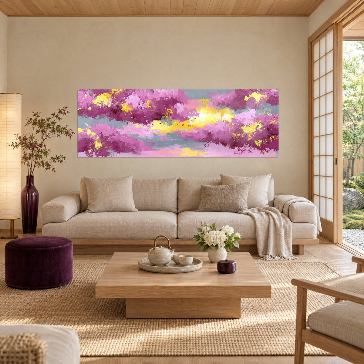 Wall art with pink clouds and golden glints, grey and lemon-yellow bands in thick impasto, above a sofa in a bright living room