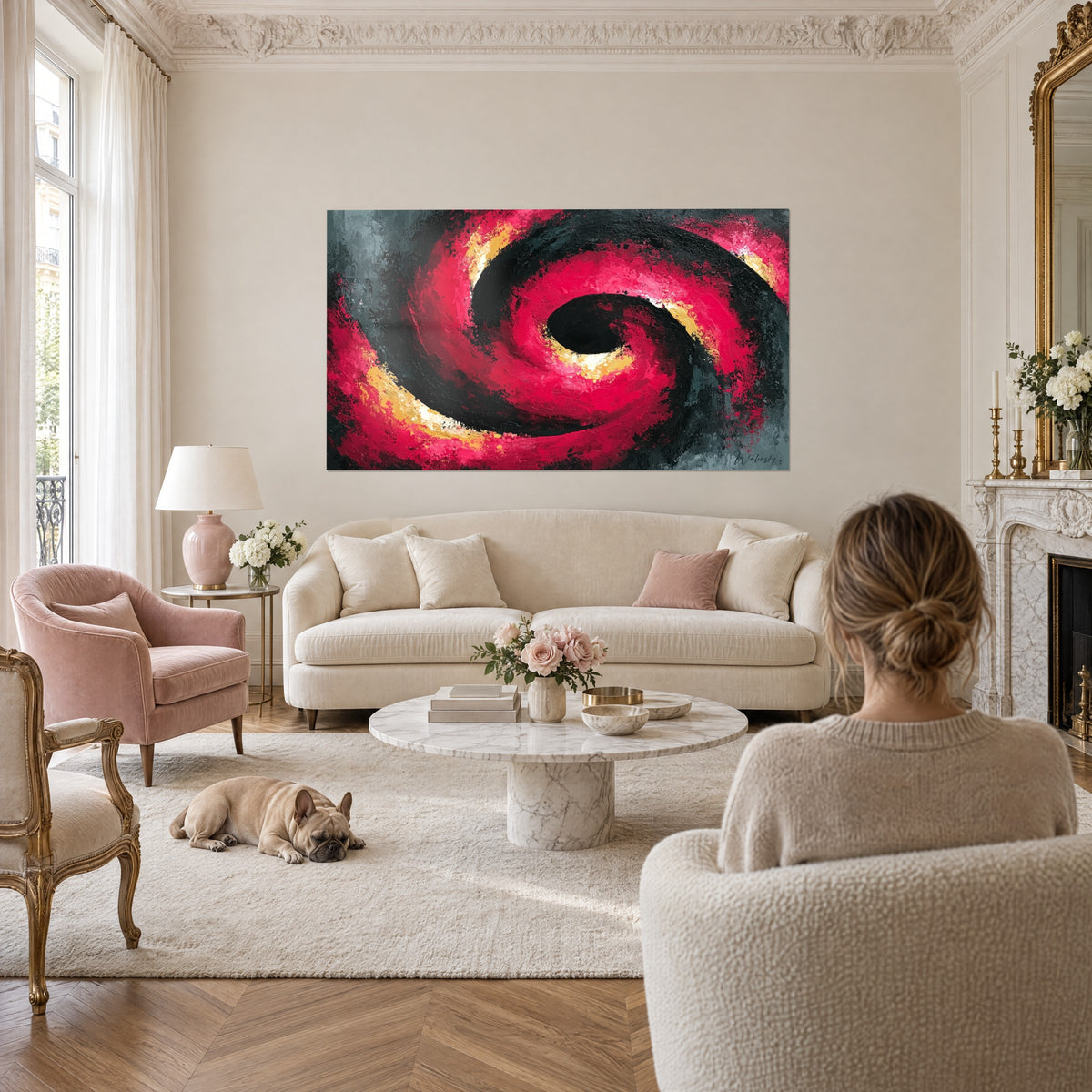 Wall art crimson and jet-black swirl, golden impasto, facing a woman seen from behind, above a sofa in a bright living room