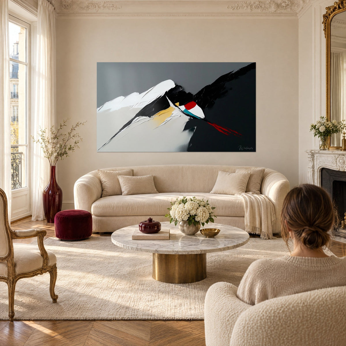 Wall art abstract summit in white and black impasto, bright red touch, two people seen from behind, above a sofa in a bright living room