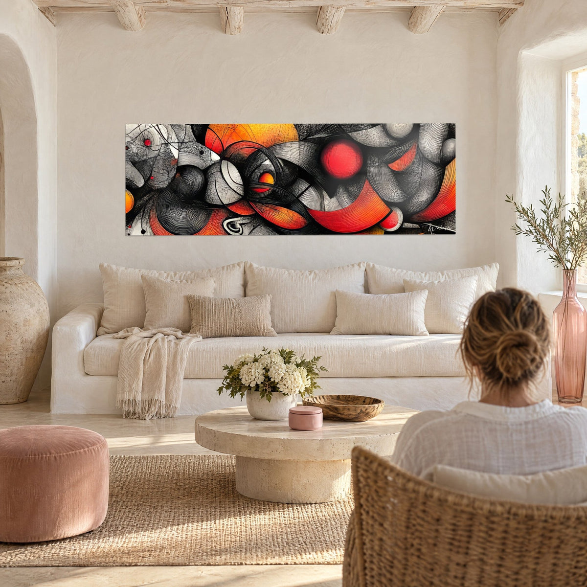 Wall art abstract red and black swirl, scarlet sphere and orange ribbons, above a sofa in a bright living room