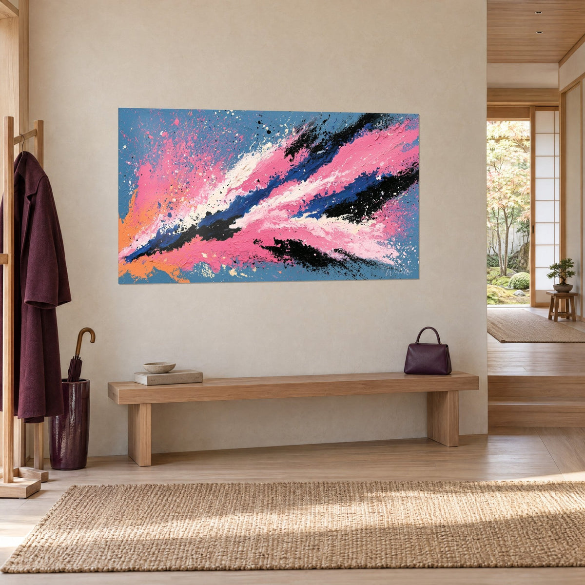 Wall art abstract rocket-shaped painting in vivid pink, royal blue and cream, hanging near a light wood bench and a coat