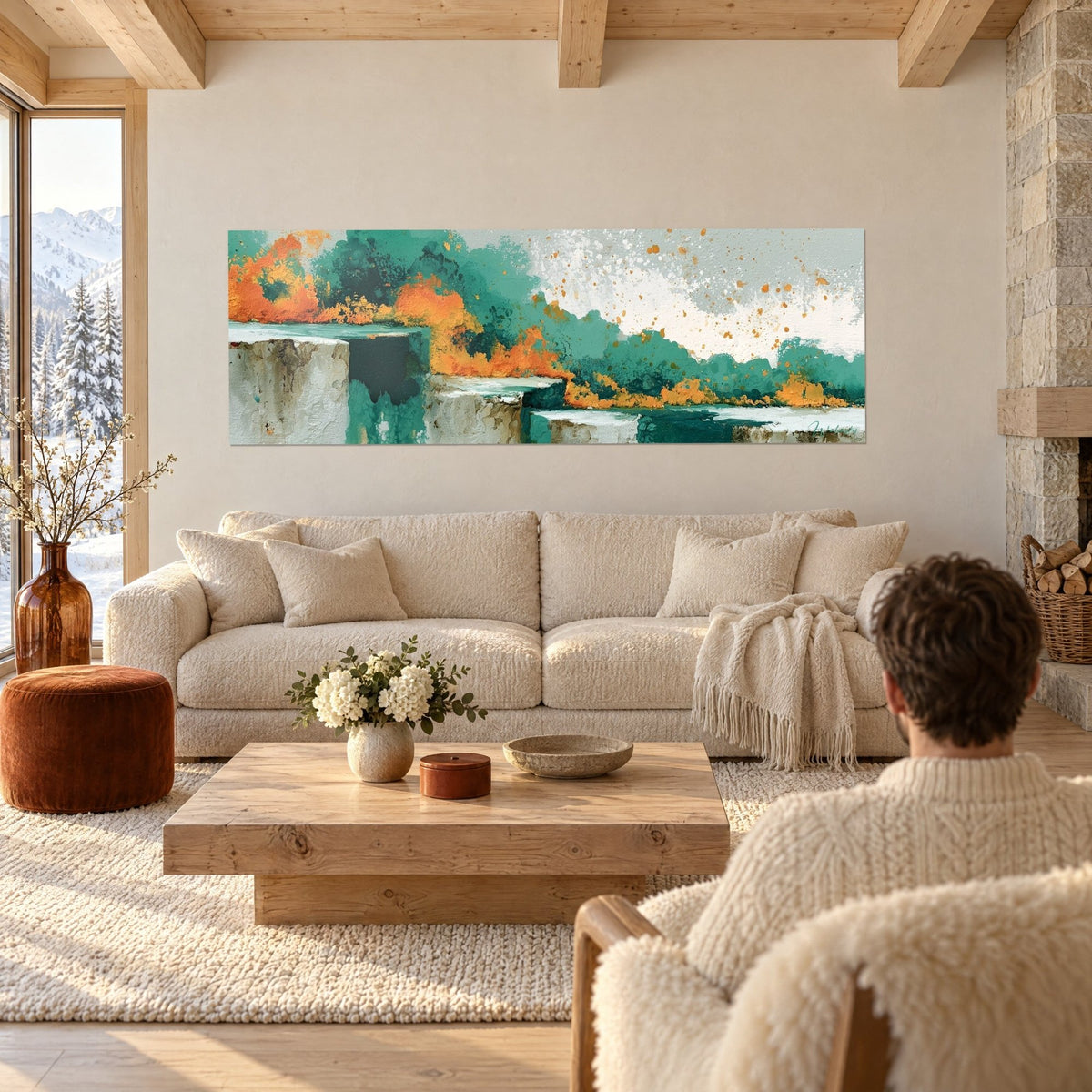 Wall art teal waves breaking into orange spray over large grey boulders, couple seen from behind, above a sofa in a bright living room