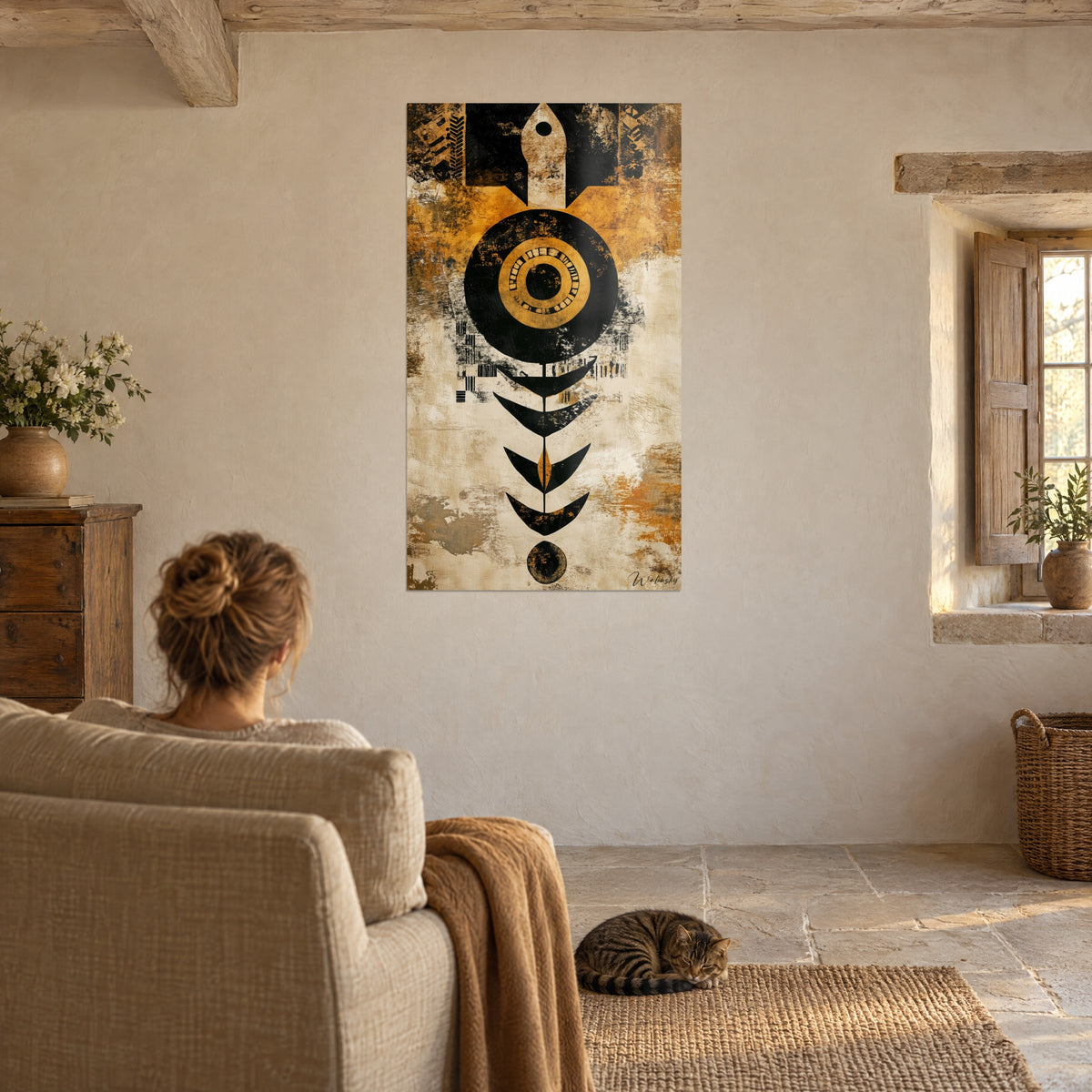 Wall art black sun with golden heart, ochre and off-white scratched textures, arrow at the summit, seen from a beige armchair with a tabby cat
