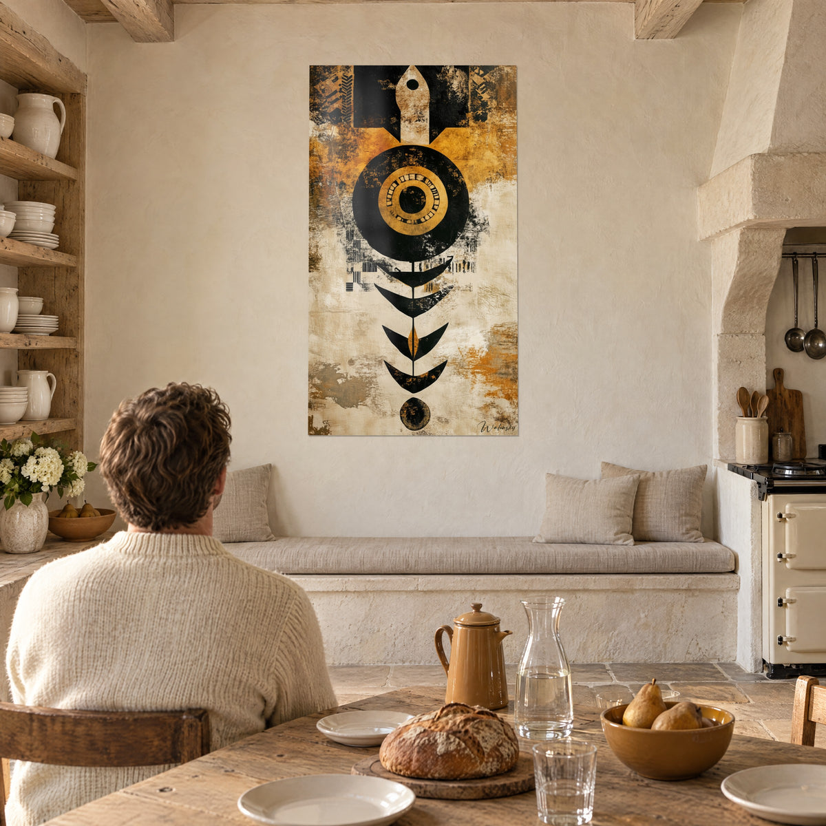 Wall art stylised African motif, golden eye in a black disc, V-shaped leaves, cream and ochre background, facing a dining table