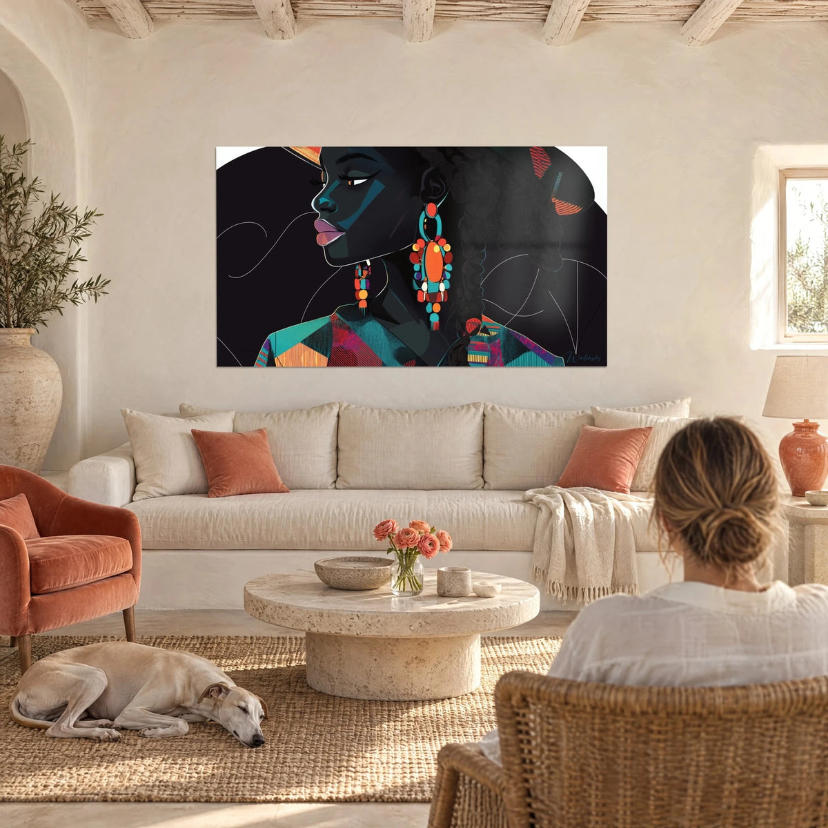 Wall art portrait of a Black woman with large orange and turquoise earrings, black background, hung above a sofa in a bright living room