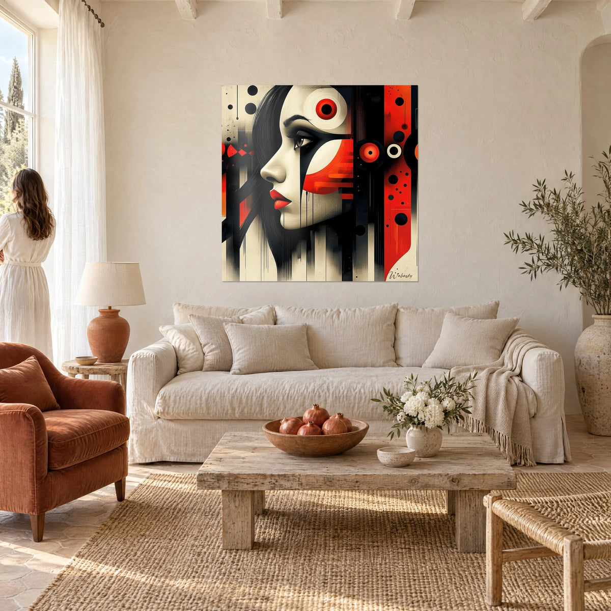 Wall art woman's face in profile, ivory skin and red lips, solid black areas, hanging above a sofa in a bright living room