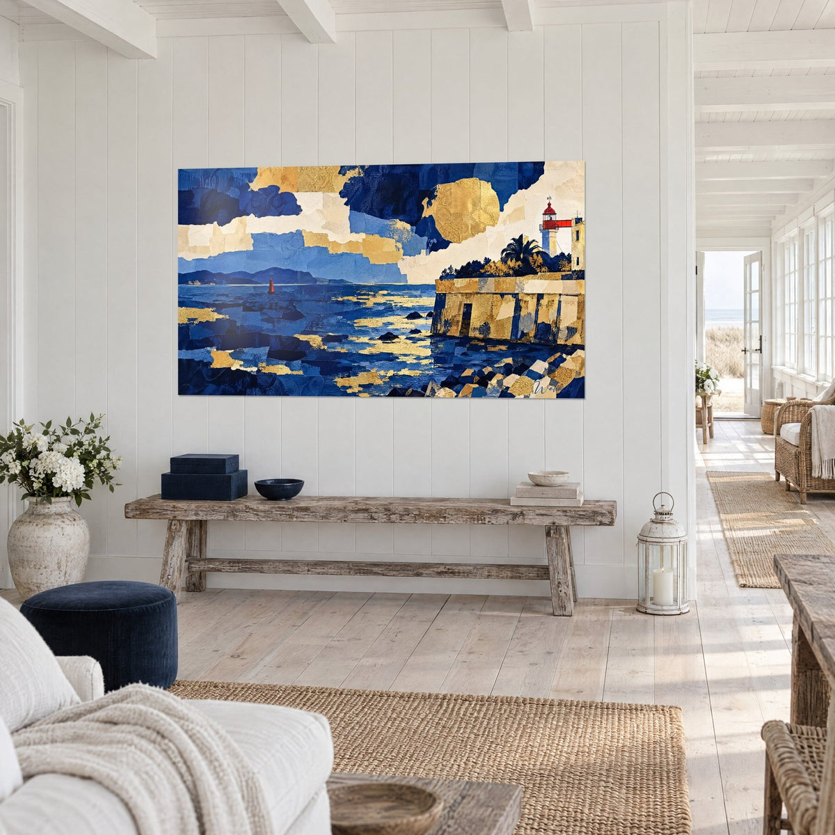 Wall art collage of cobalt blue and gold papers, ochre ramparts and red lantern, three-quarter view in a coastal home