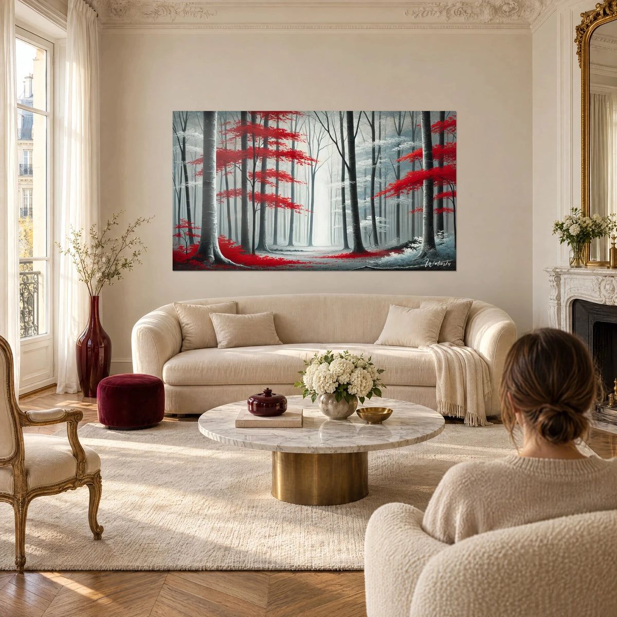 Wall art woodland path of bright red maple trees in mist, grey trunks and a clear trail, above a sofa in a bright living room