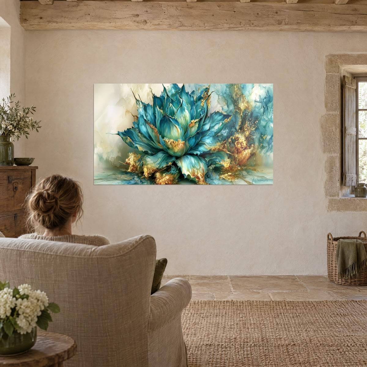 Wall art ocean-blue agave lotus with gold inlay, marbled cream background, young woman seen from behind in a beige linen armchair