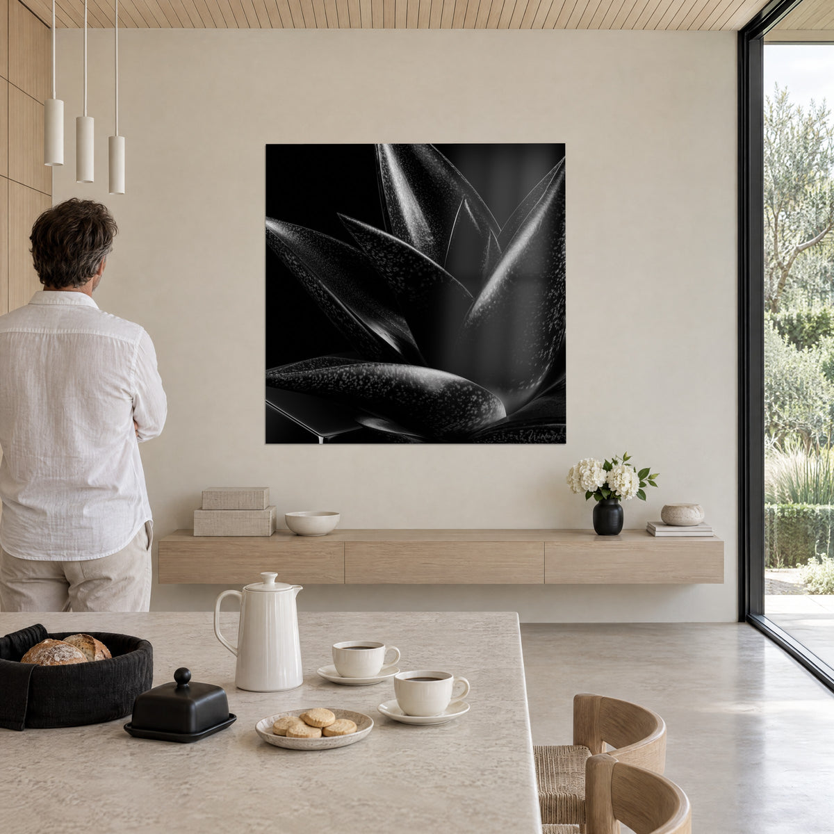 Tableau pointes d'aloès botanique monochrome, noir et gris perle, mur blanc et baie vitrée donnant sur la verdure