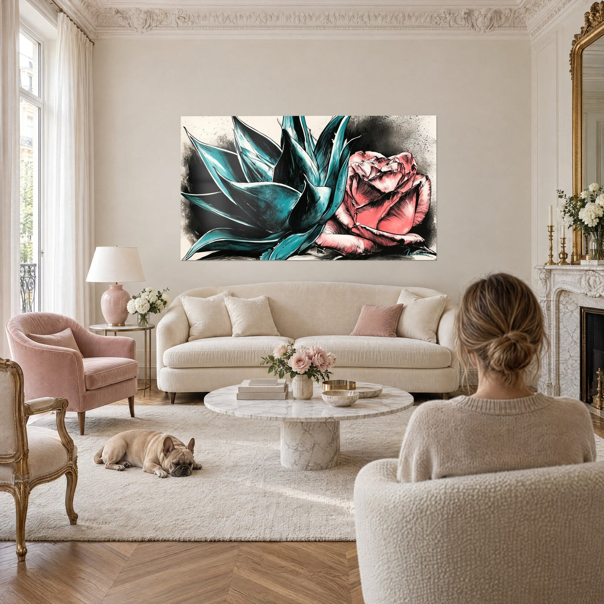 Wall art with turquoise agave and sharp leaves beside a coral rose, two people seen from behind and a bulldog, above a sofa in a bright living room