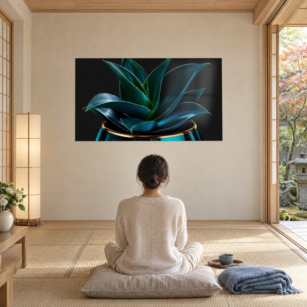 Wall art cerulean-blue aloe vera foliage, glossy gold rim on dark background, facing a person seated from behind on a cushion
