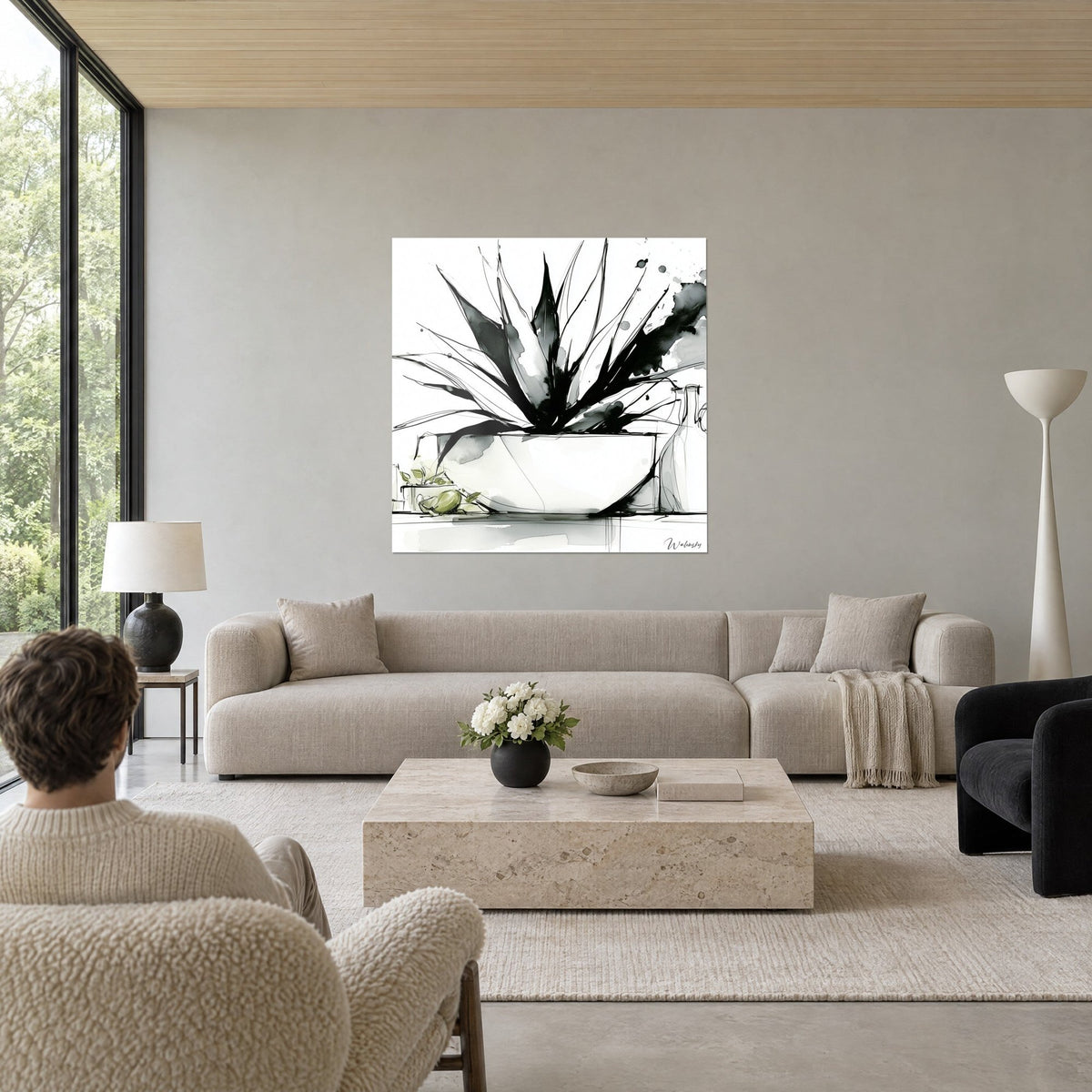Wall art of black ink agave bursting from a white bowl, grey and olive stains, above a sofa in a bright living room