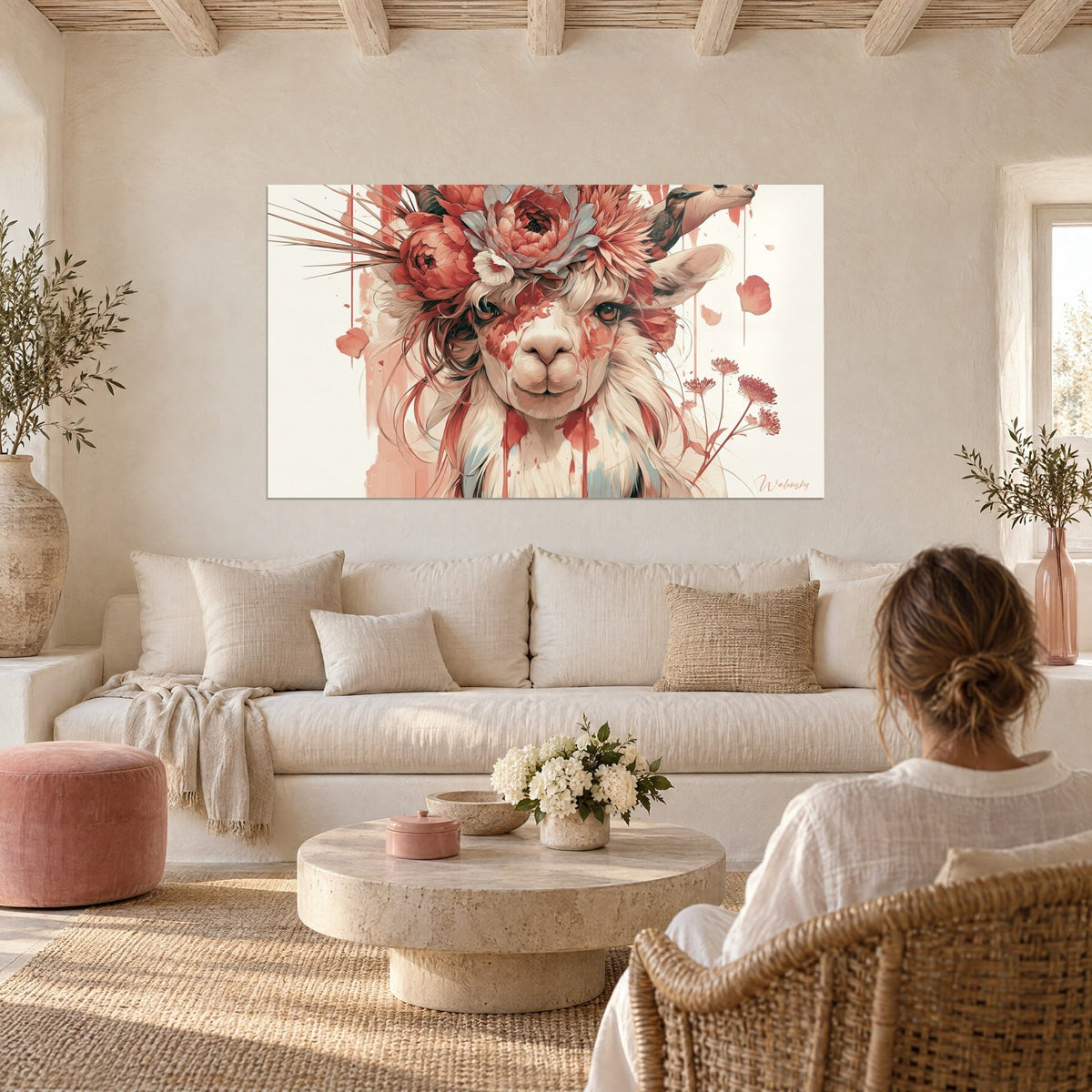 Wall art of a flowering alpaca with coral peonies and grey feathers, person seen from behind, above a sofa in a bright living room