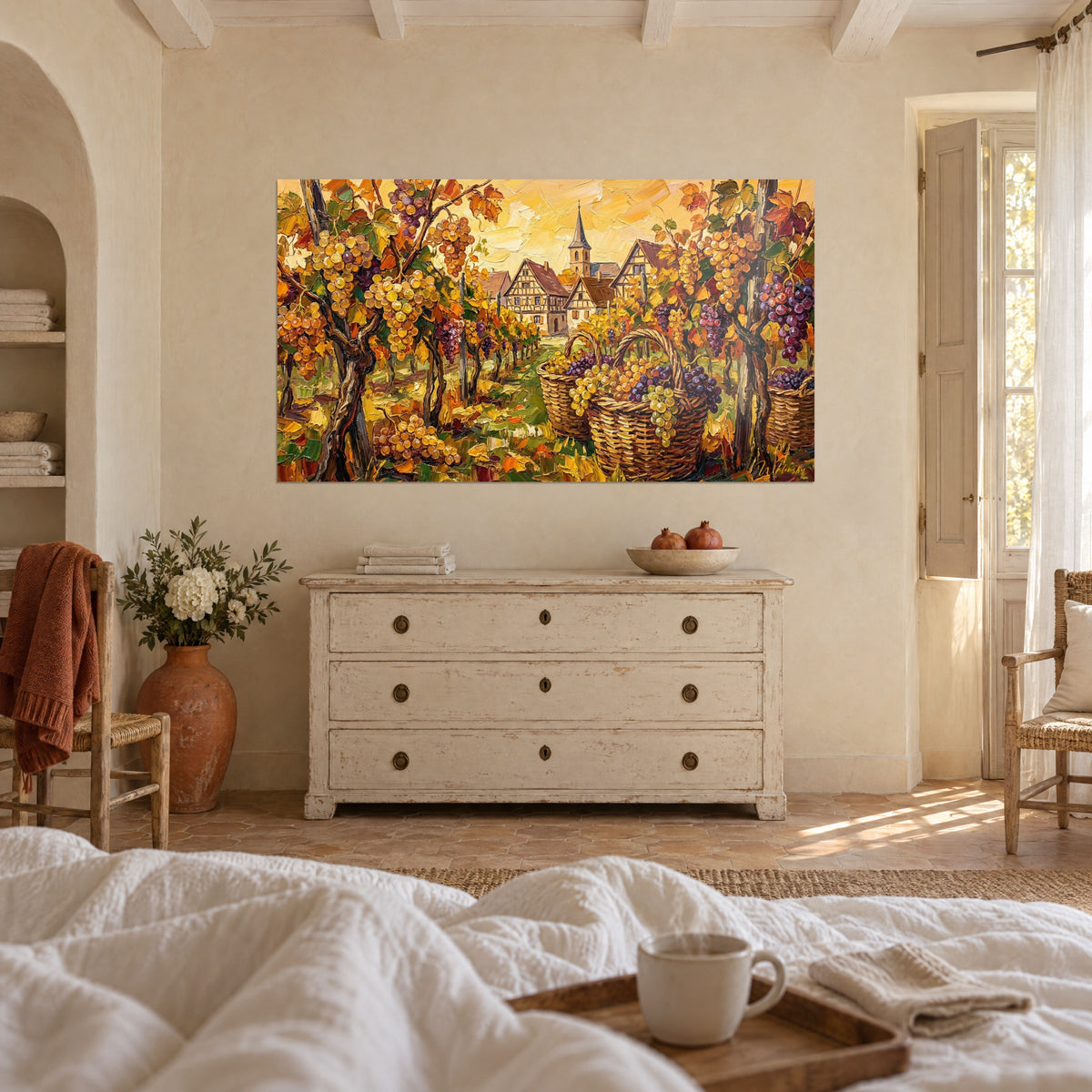 Wall art Alsatian village and vine rows in orange and honey yellow, hung above a bed in a light bedroom