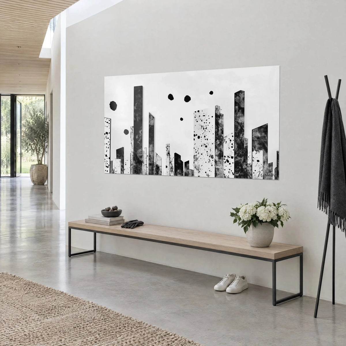 Wall art abstract skyline, charcoal cloudy towers and white splashed facades beneath ink circles, above a wooden bench with black metal frame