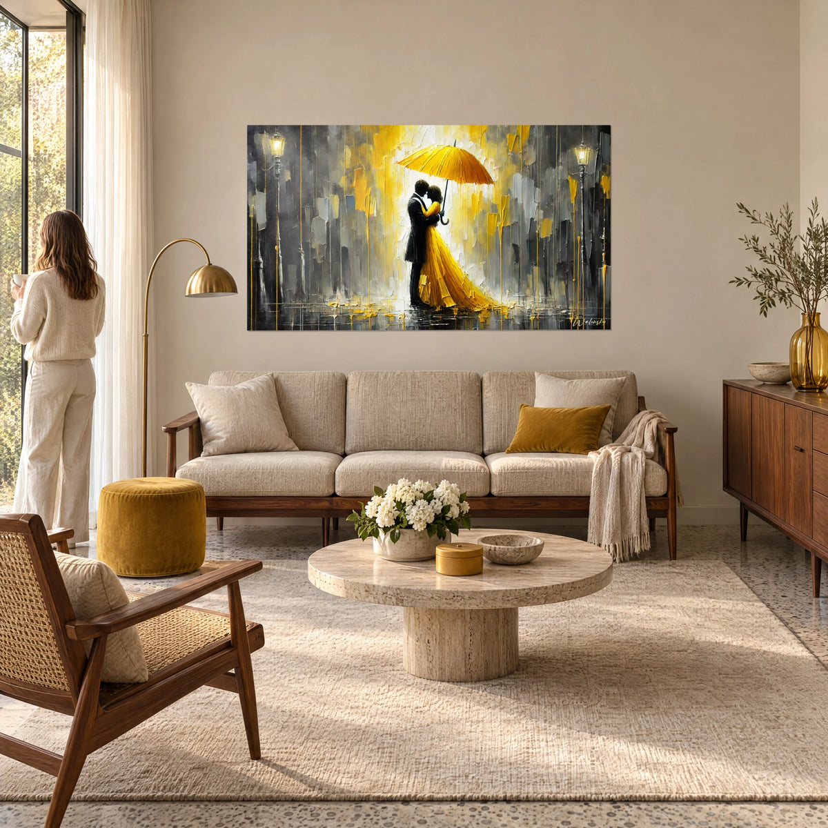 Wall art couple embracing under a yellow umbrella, saffron dress and rainy grey background, a woman seen from behind, above a sofa in a bright living room