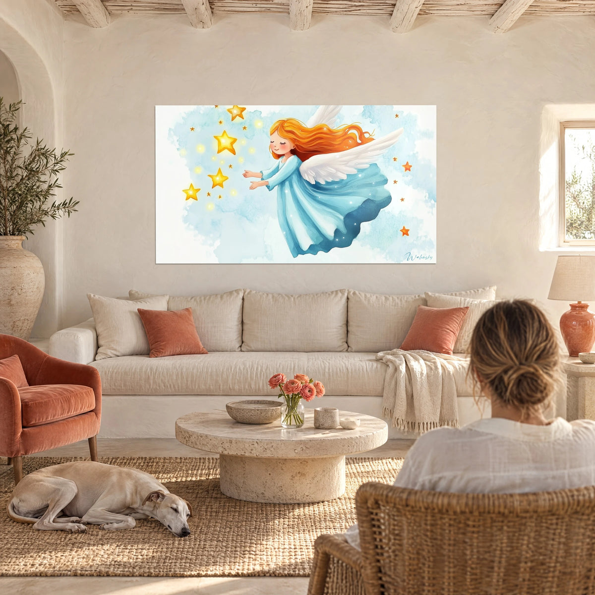 Wall art of a little red-haired angel catching golden stars against a sky-blue background, hung above a sofa in a bright living room