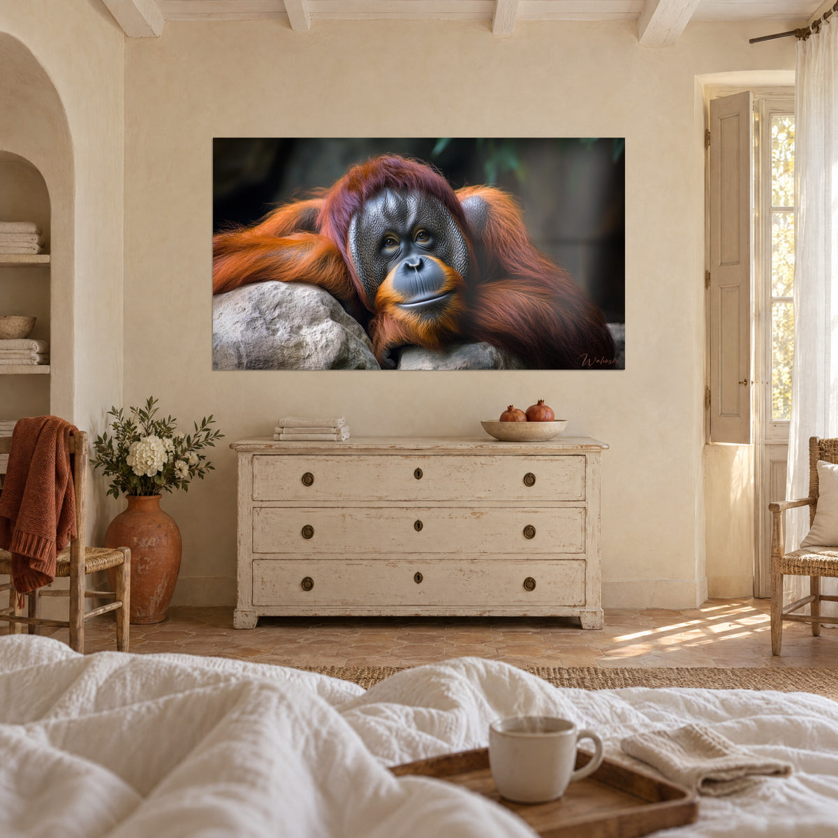 Wall art orangutan with coppery fur resting its head on a grey stone, above a bed in a light bedroom