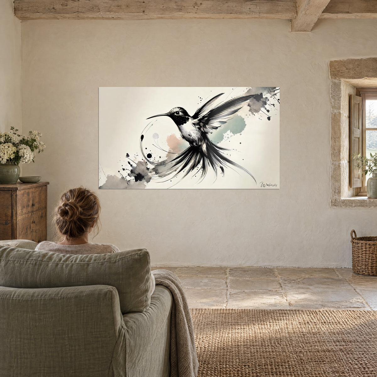 Wall art of a bird with hatched black feathers, pale pink wash and sage on a cream background, viewed from a moss green armchair