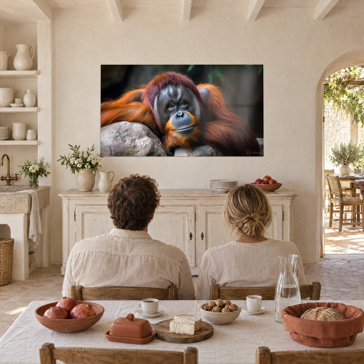 Wall art portrait of a red ape, dark wrinkled face and amber gaze, whitewashed wall, couple seen from behind at a farmhouse table