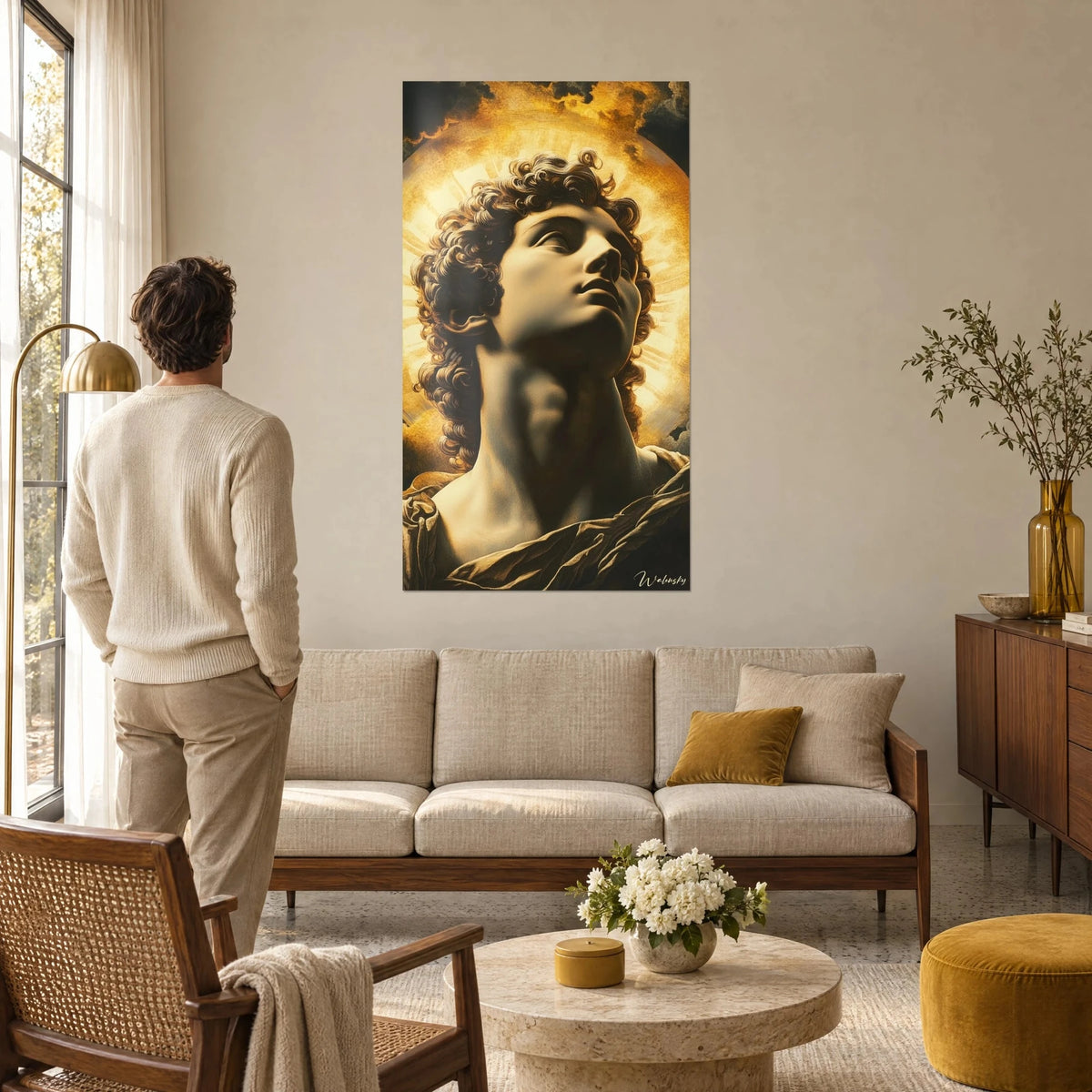Wall art Apollo bust, golden curls and ochre halo, a man seen from behind above a sofa in a bright living room