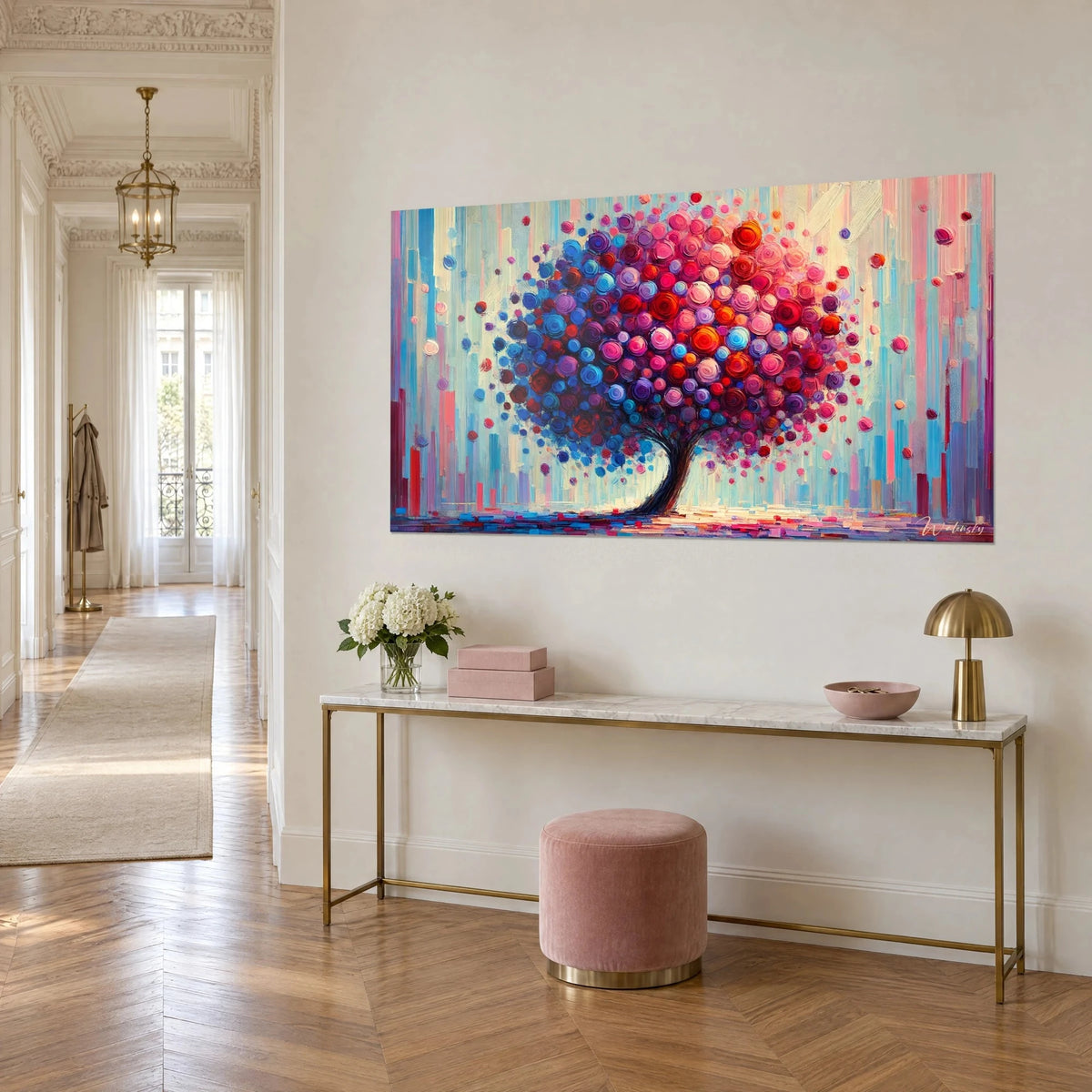 Wall art foliage of magenta, violet and orange dots on a dark trunk, hung above a gilded console table