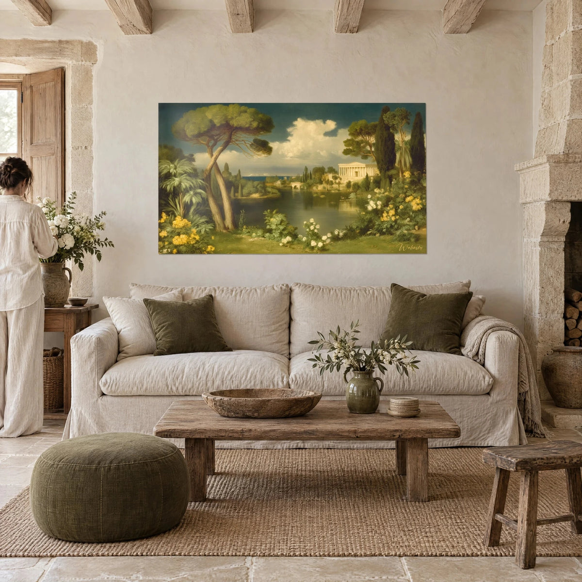 Quadro paesaggio arcadico con pini a ombrello, lago scuro e tempio bianco, fiori gialli, donna di spalle, sopra un divano in un soggiorno luminoso